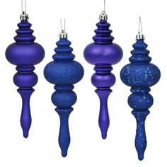 three blue christmas ornaments hanging from strings