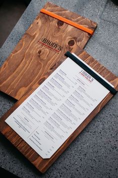 a menu sitting on top of a wooden cutting board