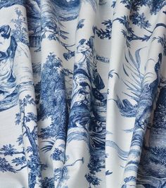 a curtain with blue flowers and leaves on it