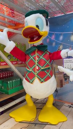 an inflatable duck dressed as a drummer stands on one leg and holds his arms out