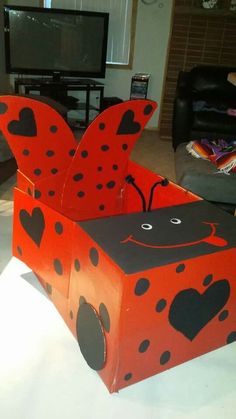 a cardboard box shaped like a ladybug sitting on top of a white table