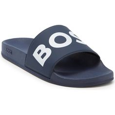 Rubber Slip-On Sandals In Navy Blue. Open Round Toe. Logo Embossed In White At Vamp. Molded Foam Rubber Footbed. Tonal Rubber Midsole Featuring Embossed Logo At Outer Side. Tonal Treaded Rubber Outsole. Sporty Slides By Boss, Crafted In Italy. Set On A Contoured Sole, These Slides Are Topped With A Rubber Strap Carrying A Logo For Statement Style. A Further Logo Sits Tonally At The Side For A Signature Finish. Fastening Top: Slip-On Unlined Sole: Other Material Made In Italy! Casual Blue Slip-on Sandals, Blue Rubber Sole Slides Slip-on, Blue Slip-on Slides With Rubber Sole, Blue Slides With Branded Insole And Round Toe, Blue Synthetic Slides With Rubber Sole, Blue Slides With Cushioned Footbed And Round Toe, Navy Slip-on Slides For Summer, Casual Slip-on Sandals With Contrast Sole, Navy Slides With Cushioned Footbed For Summer