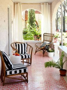 the porch is decorated with black and white striped furniture