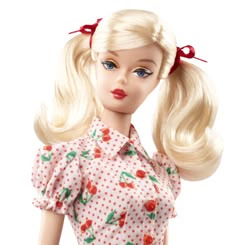 a barbie doll with blonde hair and polka dot dress on it's head, wearing a red bow in her hair