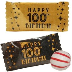 two birthday candy bars and one with a striped ball on the top, both decorated in black and gold