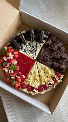 a box filled with assorted desserts on top of a table