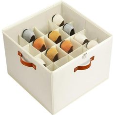 a white storage box filled with lots of different colored balls and thread spools