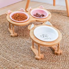 three wooden bowls with food in them sitting on top of a rug next to each other