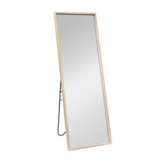 a mirror that is sitting on top of a stand in front of a white wall