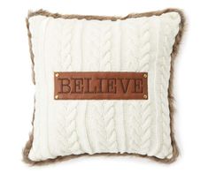 a pillow with the word believe on it and a leather patch in the middle that says,