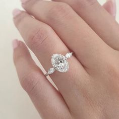 a woman's hand with a diamond ring on it