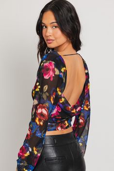 Long sleeve cowl neck floral printed top with scoop open back. Wear a bralette or cami under. Model is wearing a small Store Location: Hampden Spring Party Cowl Neck Top, Cowl Neck Top With Sleeves, Black Spring Cowl Neck Tops, Cowl Neck Top Bra, Metallic Cowl Neck Top, Small Store, Sheer Floral Blouse, Cowl Neck Top, Floral Print Tops