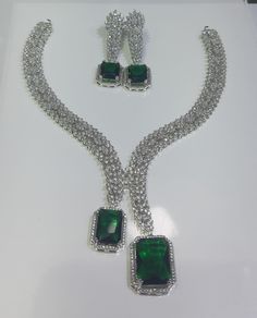 Faux CZ Diamonds Green Necklace Earrings Set, Bridal Dangler Earrings, Bridal Choker, Party Wear Emerald Necklace Earrings, Statement Piece ITEM DESCRIPTION Metal        = Silver Plated Occasion  = Wedding, Party Wear, Bridal Color        = White and Green Size          = Necklace Length = 7 Inches Long, Earring Size = 22 Inches Long,  Free Shipping 100% Satisfaction Guarantee: 1 Year Warranty, Long Lasting Plating, High-Quality Stones Occasion: Perfect choice for any Indian occasion.  Care: It Green Sparkling Stones Jewelry Sets For Party, Green Crystal Jewelry For Party, Cubic Zirconia Costume Bridal Necklace For Parties, Dazzling Green Jewelry For Party, Green Crystal Jewelry For Evening, Party Dangle Necklaces With Matching Earrings, Party Jewelry Sets With Matching Cubic Zirconia Earrings, Green Dangle Jewelry For Party, Green Dangle Party Jewelry