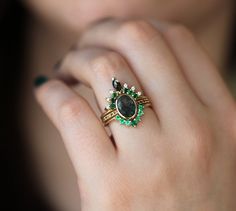 a close up of a person's hand with a ring on their finger,