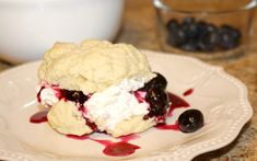 a plate topped with ice cream and blueberries