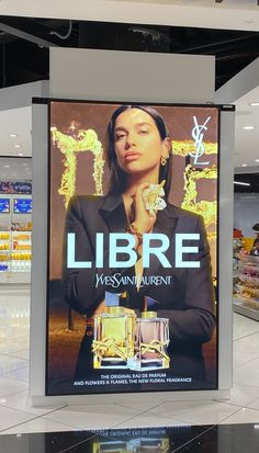 there is a billboard in the middle of an empty store floor that says libre miss saint laurent