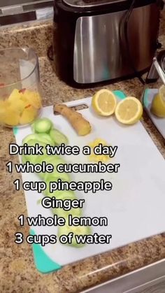 a cutting board with lemons and cucumbers on it next to a slow cooker