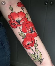 a woman's arm with red flowers on it