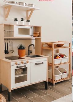 a kitchen with white cabinets and wooden shelves