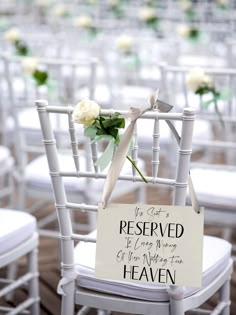 a white chair with a sign that says it's not reserved to be married