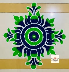 a blue and green circular design on the wall