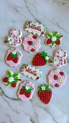 decorated cookies are arranged on a marble surface