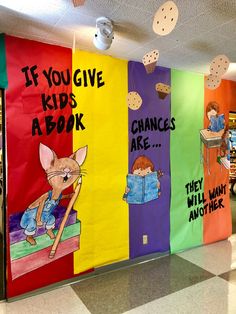 colorful bulletin boards with children's books written on them in the hallway at an elementary school