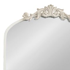 a large white mirror with an ornate design on the top and bottom half of it