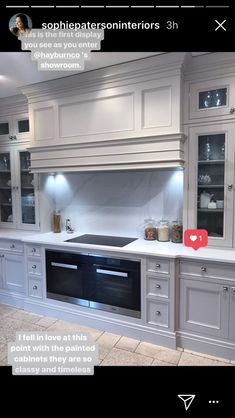 a kitchen with white cabinets and an appliance on the wall next to it