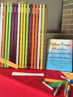 the table is set up with colorful paper and crayons