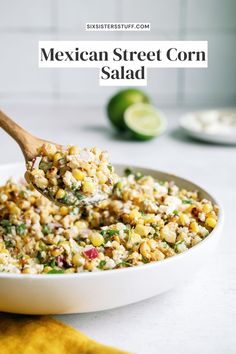 mexican street corn salad in a white bowl with a wooden spoon