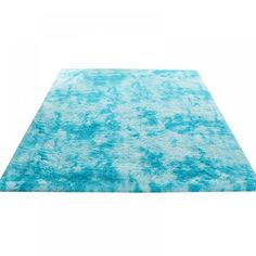 a blue and white area rug on a white background