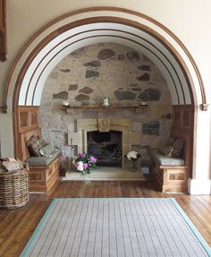 a living room filled with furniture and a fire place in the middle of a room