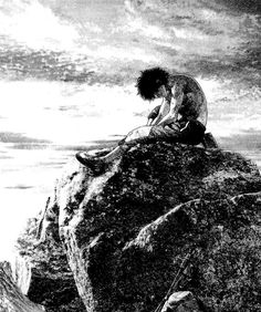 a man sitting on top of a rock next to the ocean