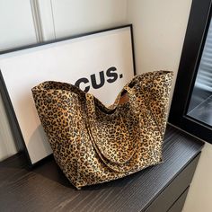 Indulge in Luxury with Our Oversized Leopard Prints Shoulder Bag Elevate your style and embrace sophistication with our Oversized Leopard Prints Shoulder Bag. Crafted from high-quality canvas material, this spacious tote combines fashion and functionality, making it a must-have accessory for the modern woman. Product Features: Premium Quality: Made of durable canvas fabric, our shoulder bag offers long-lasting performance and resistance to wear and tear, ensuring years of reliable use Stylish De Shopping Totes, Leopard Prints, Printed Canvas Tote Bag, Beg Tangan, نظارات شمسية, Brown Leopard, Casual Tote, Canvas Shoulder Bag, Types Of Bag