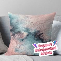 a throw pillow with the words support independent artists on it in pink, blue and white