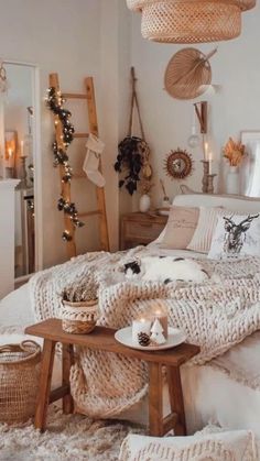 a bed with blankets, pillows and candles in a room decorated for christmas or new year's eve