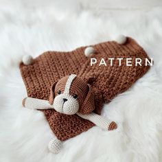 a knitted dog laying on top of a blanket with the words pattern above it