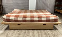 a bed sitting on top of a wooden platform