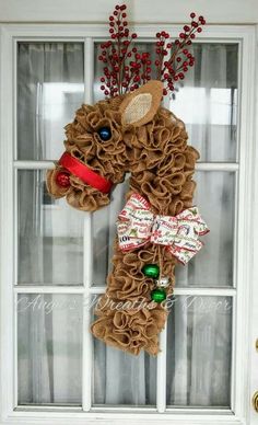 a christmas wreath hanging on the front door