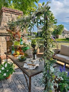 an outdoor patio with potted plants on the table and other items in front of it