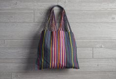 Handwoven With Love These versatile totes are handwoven by artisans in Chiapas, Mexico, on a backstrap loom. Perfect for the farmer's market, a day at the pool or beach, or as an everyday purse! Each bag has vibrant stripes of color which carry on to the straps which are then intertwined with the base color of the bag. The tops of the straps are double wrapped to provide strength and comfort for your shoulder or your hands. How They Are Made The backstrap loom is a traditional style of looming i Hammock Bag, Backstrap Loom, Laptop Tote Bag, Everyday Purse, Vegan Leather Bag, Farmer's Market, Eco Friendly Gifts, Market Bag, Woven Bag