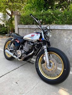 a motorcycle parked next to a cement wall