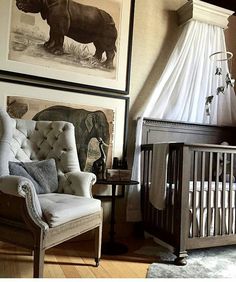 a baby crib with pictures on the wall above it and an elephant in the background