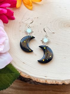 ✨ Created with polymer clay, sealed with resin. ✨ Earring hooks are silver plated, hypoallergenic/nickel free. Jump rings are stainless steel. ✨ Made to order. Please allow 10-14 business days before your order will be shipped. Nickel-free Black Polymer Clay Jewelry, Unique Moon Phase Earrings For Gift, Handmade Whimsical Moon Earrings, Whimsical Moon-shaped Handmade Earrings, Unique Sun And Moon Design Earrings As Gift, Unique Moon Charm Earrings As Gift, Whimsical Silver Resin Jewelry, Hypoallergenic Half Moon Jewelry Gift, Unique Handmade Moon-shaped Earrings