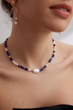 Baroque Pearls Choker with Lapis Lazuli, a Seaside-inspired Piece Of Jewellery The Navy Blue Lapis Lazuli Beads with Baroque Pearls Choker by Señorita J is a beautiful piece that blends the beauty of the ocean with timeless design. This lovely choker has a gold chain with a variety of carefully chosen materials on it, such as pearl beads that shine like diamonds and lapis lazuli beads that are a deep, calm navy blue. There are also small gold beads scattered throughout the chain. The four large Natural Pearl Necklace, Unique Handcrafted Jewelry, Lapis Lazuli Necklace, Lapis Lazuli Beads, Silver Pearl Necklace, Blue Lapis Lazuli, Blue Lapis, Natural Pearl, Wedding Jewellery Necklace