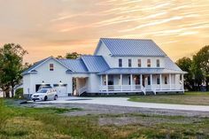 a white truck parked in front of a large house on the side of a road