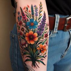 a woman's arm with colorful flowers on it