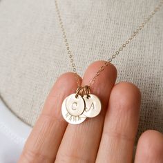 "Gold filled Nana necklace personalized with initials. A sweet and simple gift for grandma, that she will truly cherish. Personalized with grandchildren's initials. Dainty, timeless, perfect for every day. FEATURES: * high-quality gold filled discs are hand finished, * the large disc is carefully hand stamped with the word \"NANA\", * small discs will be stamped with initials of your choice, * delicate gold filled chain is finished with a spring clasp closure. MEASUREMENTS: * 14K gold filled lar Dainty Initial Necklace Perfect For Mom, Dainty Initials Necklace Gift For Mom, Dainty Initial Necklaces As A Gift For Mom, Dainty Initials Necklace As Gift For Mom, Dainty Initials Necklace For Mom, Custom Name Initial Pendant Charm Necklace For Mom, Mother's Day Initials Charm Necklaces For Mom, Mother's Day Initials Charm Necklace Gift For Mom, Mother's Day Gift Initials Charm Necklaces