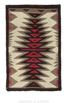 an old navajo rug with red, brown and white designs on the bottom half of it